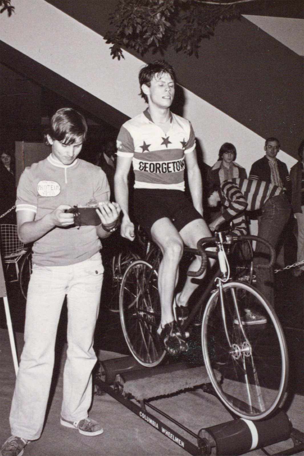Allen riding the rollers in his Georgetown jersey while a helper times him